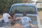 Police catch children swimming in the bed of moving pickup truck