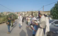 Jewish residents pray at entrance to Arab village
