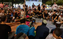 Tel Avivians read Lamentations outside open restaurant