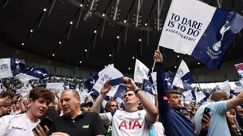 Tottenham Hotspur fans wave flags at Tottenham Hotspur Stadium in London, Aug. 1