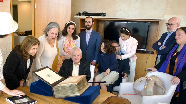 Alfred Moses examines the Codex Sassoon surrounded by family and friends.