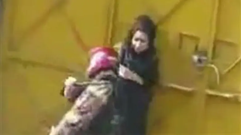 Iranian policeman beats woman protester