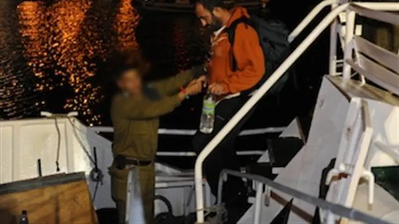 IDF soldier helps flotilla member off ship