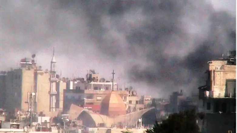 Smoke rises from Syrian shelling of Homs
