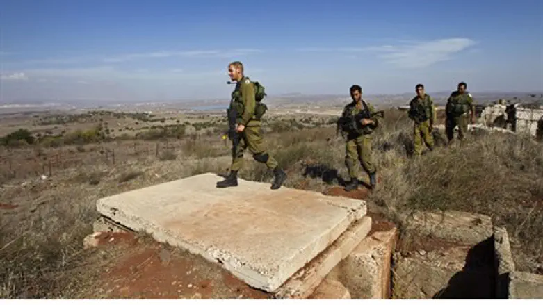 Israeli soldiers patrol the area near the Syr