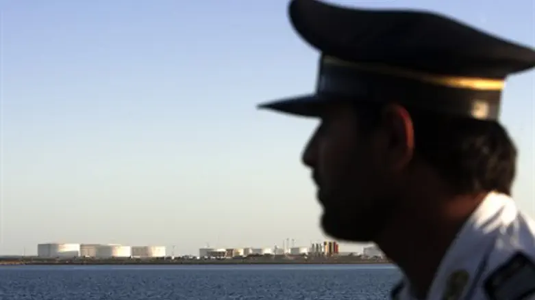 A security officer looks on at oil docks east