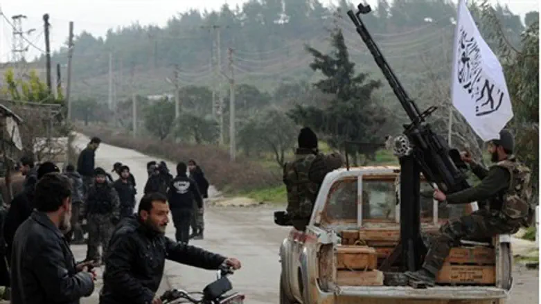 Syrian rebels patrol in the northwestern town