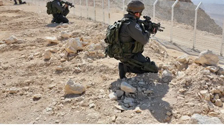Israeli soldiers stand guard at Sinai border