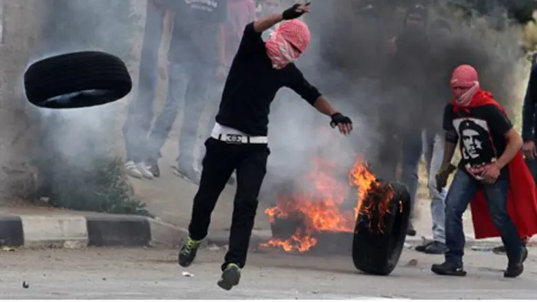 Arab rioters roll burning tires for 'Nakba Da