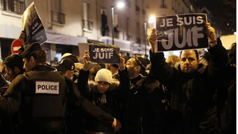 Demonstrators hold up signs reading "I am Jewish" in Paris