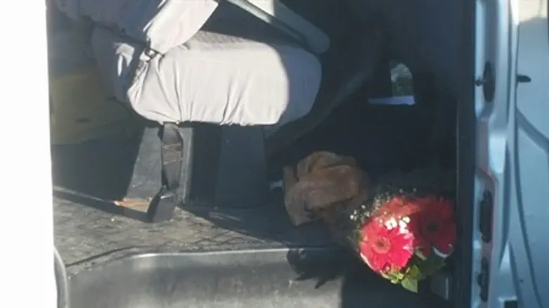 Flowers lay strewn inside the victims' car