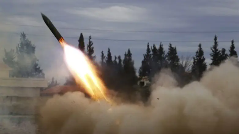 Jaish Al-Islam fighters launch a rocket from Ghouta