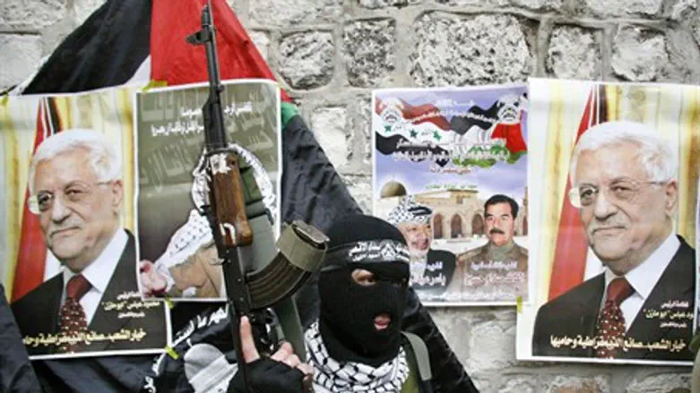 Fatah Al-Aqsa Martyrs Brigade terrorist with Mahmoud Abbas's picture (file)
