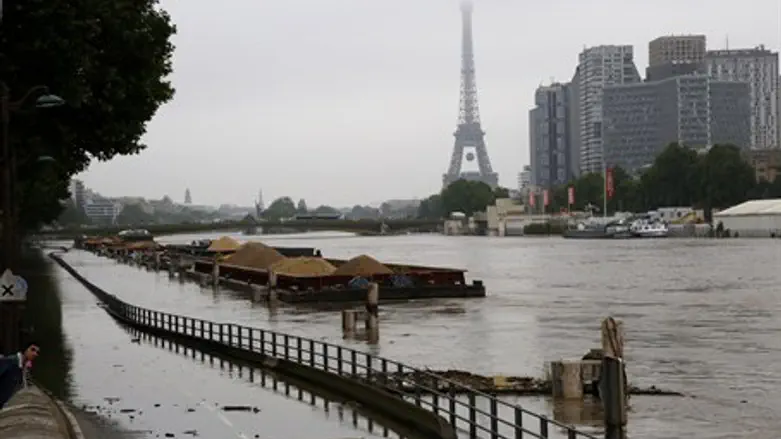 River Seine floods in Paris with Eiffel Tower in background
