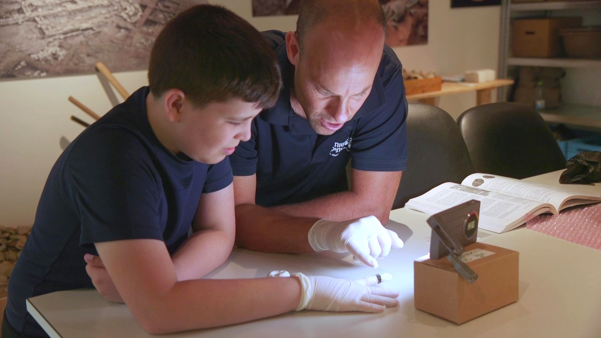 Dr. Eitan Klein of the Israel Antiquities Authority and Yair Whiteson examining the ring in the laboratories of the Jay and Jeanie Schottenstein National Campus for the Archaeology of Israel in Jerusalem. Credit: Emil Aladjem, Israel Antiquities Authority
