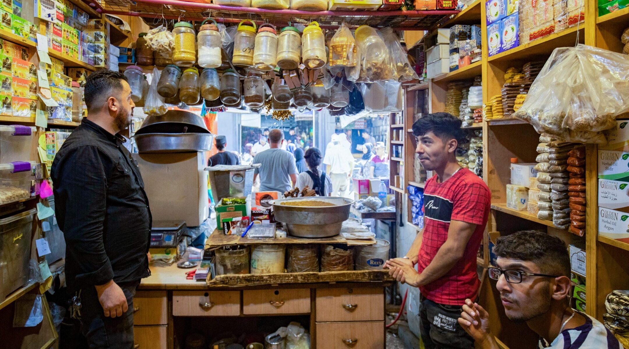 A shopkeeper helps a customer at the Azra Alyahoodi (Azra the Jew) market also known as the "Jewish market," in the city of Qamishli in northeastern Syria, on July 27, 2023. Photo by Delil Souleiman/AFP via Getty Images