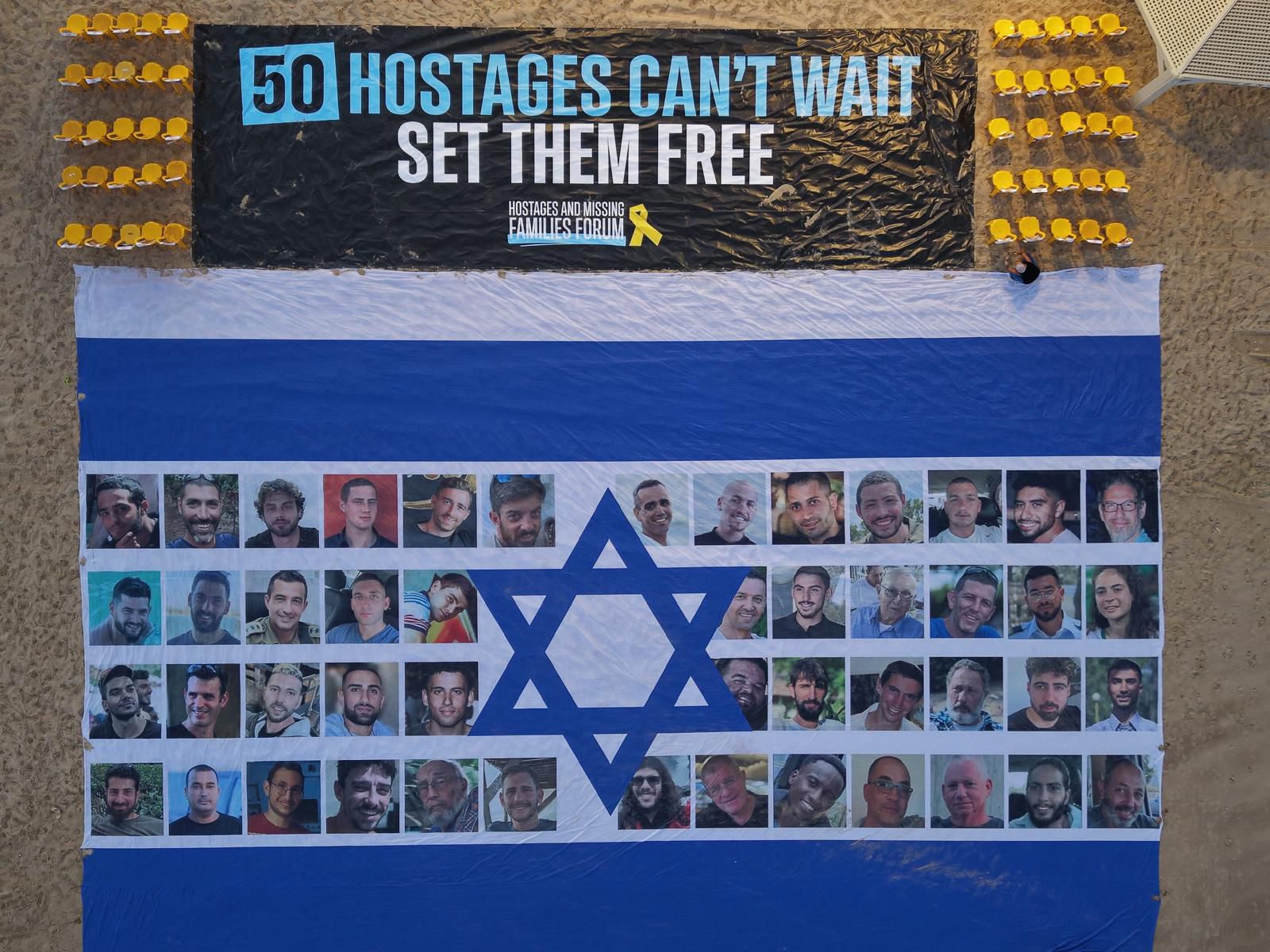 The flag with the photos of the hostages