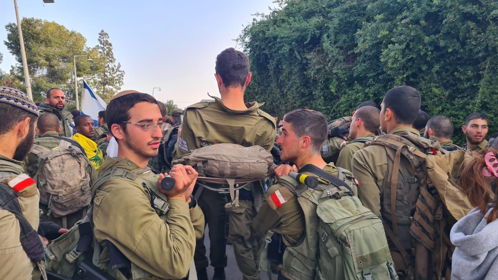 Dvir holds heaavy stretcher on Golani beret-earning march