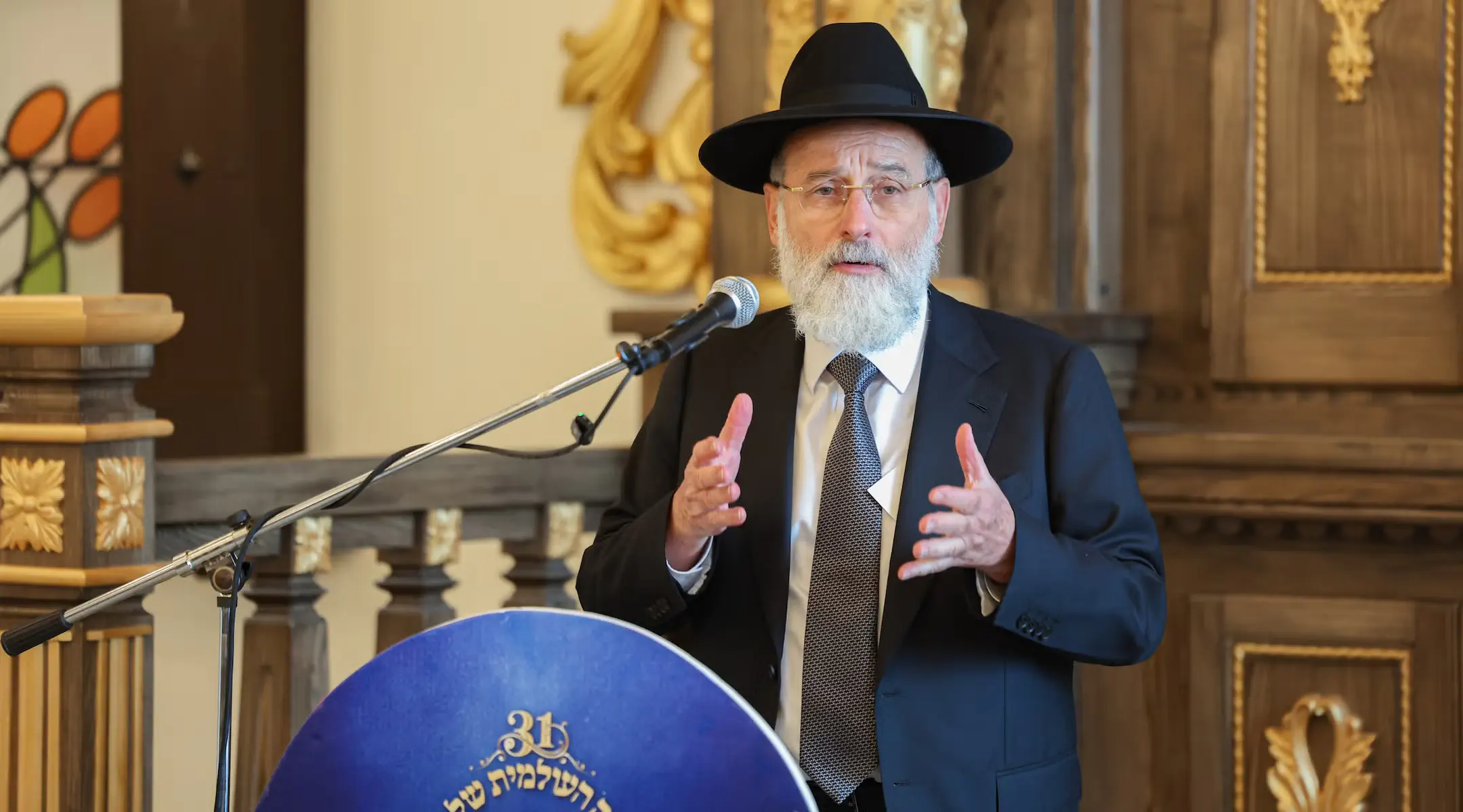 Rabbi Dovid Hofstedter speaks at the restored Radin Yeshiva. Credit: A. Aizenbach