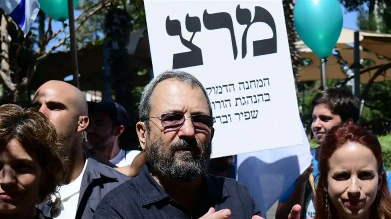 Ehud Barak in front of Meretz poster 