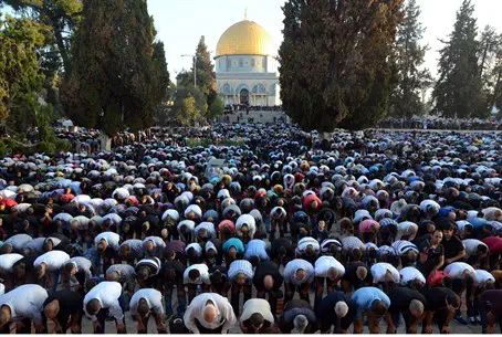 Muslims pray towards Mecca from Temple Mount