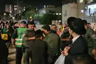 Police officer recorded slapping haredi protester