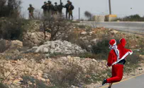 Watch: 'Santa' throws stones at Israeli forces