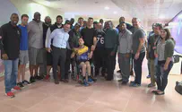 Children with disabilities play football with NFL players