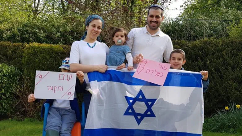 The Lemberger family holds an Israeli flag
