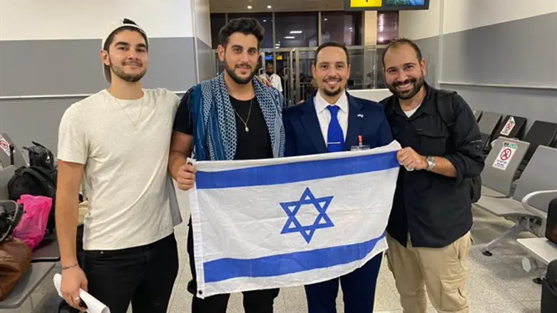 The three who were freed, with the Israeli representative 