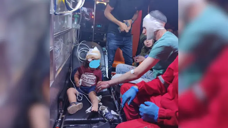 Yedidya Strook with his 2-year-old son in the ambulance