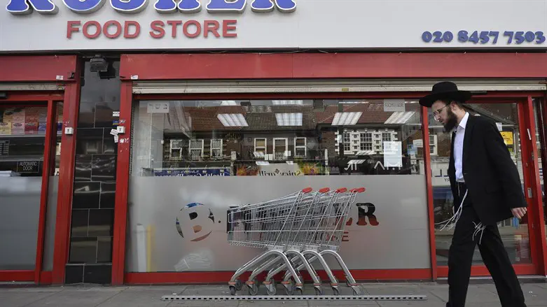 Man walks past kosher store, Golders Green