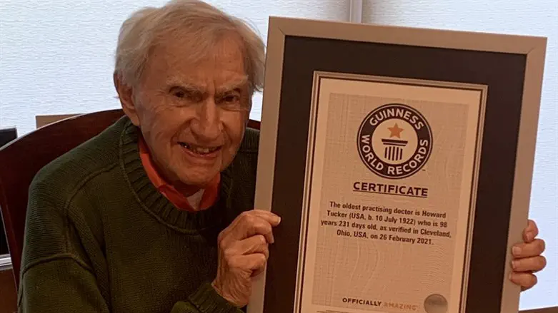 Dr. Howard Tucker holds the Guiness World Records certificate recognizing him as