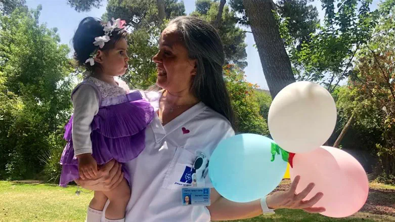 Hadassah and her nurse at her first birthday party