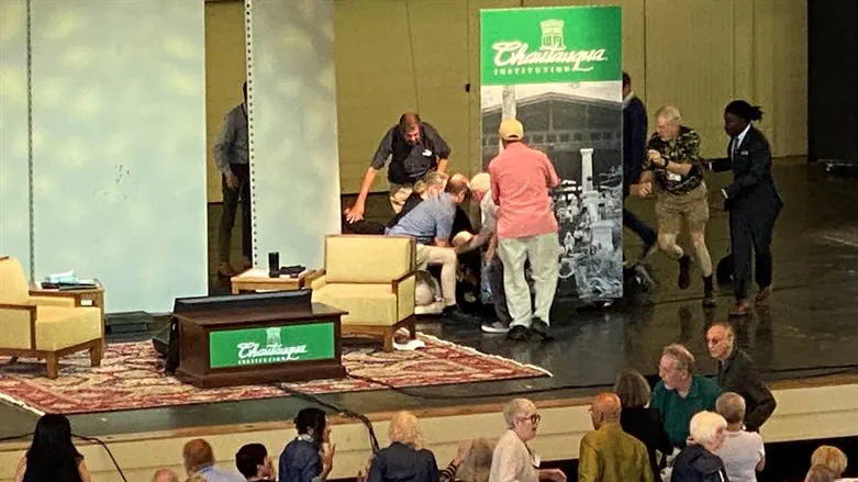 Author Salman Rushdie is helped by people after he was stabbed at the Chautauqua