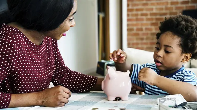 Mom and son saving money to piggy bank