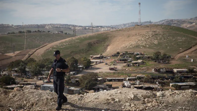 Policeman on hill overlooking Khan al Akhmar