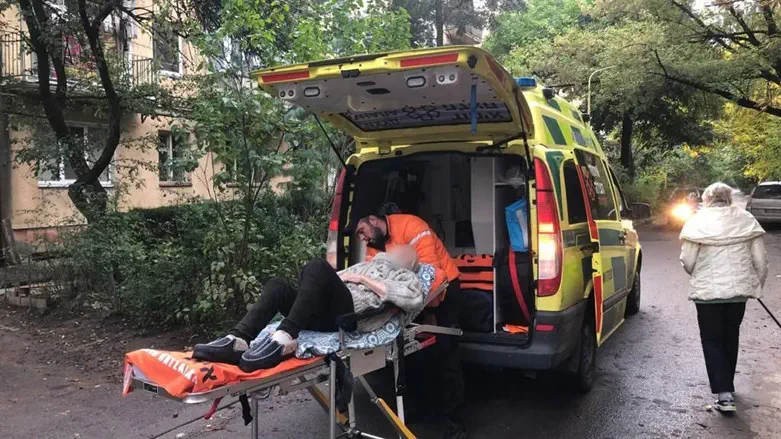 Vadim taking the woman out of the ambulance in Uzghorod