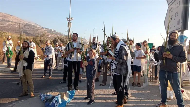 Jewish residents hold holiday prayers at the entrance to Shechem