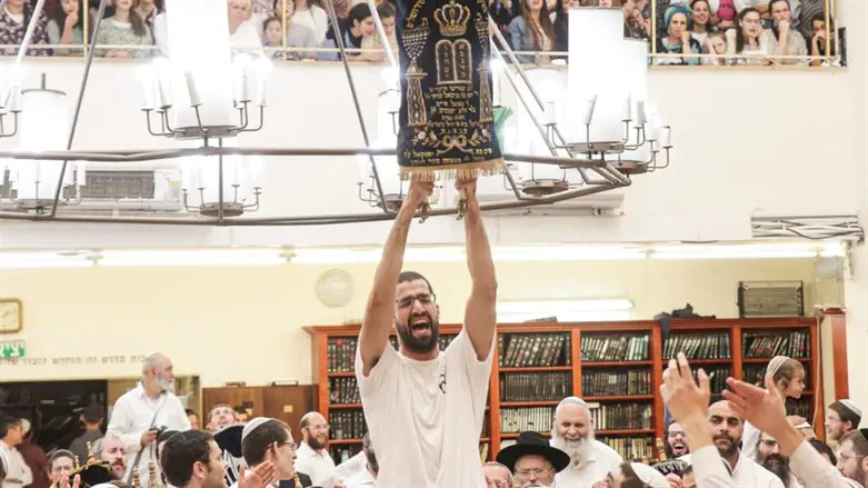 A student with a Torah scroll