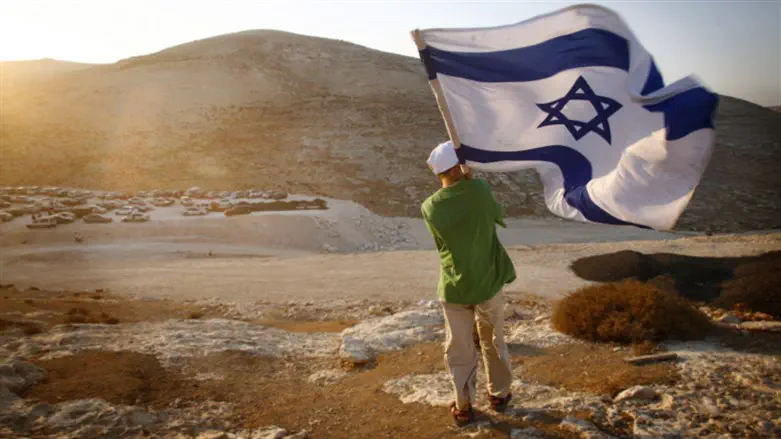 Jew holding Israeli flag in land of Israel 