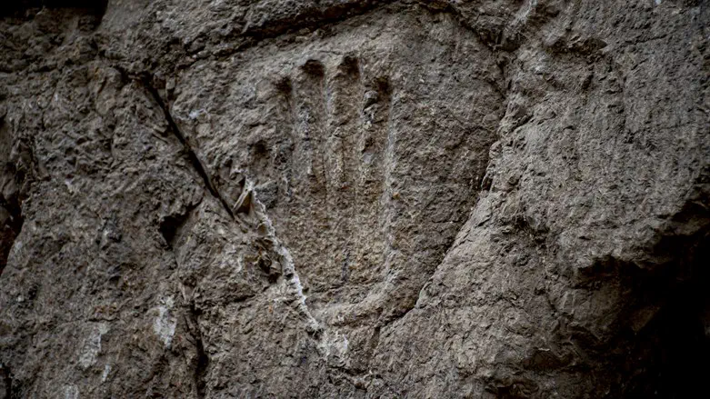 The carved hand on the moat wall.