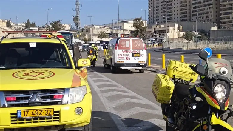 MDA teams wait to recive the victims at the entrance to the Shuafat Camp
