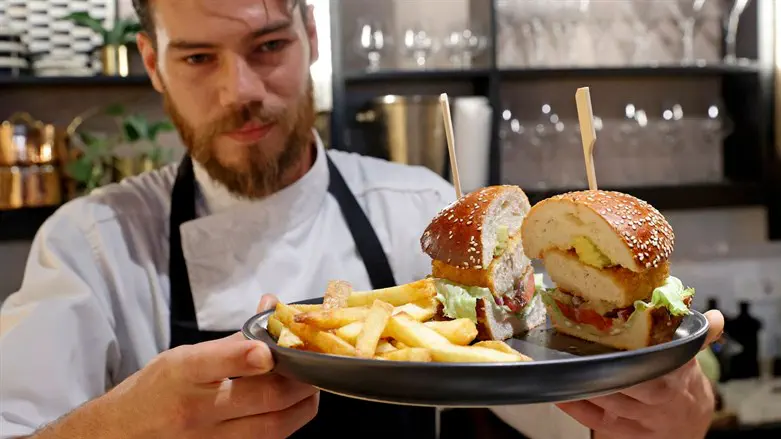 Israeli chef Shachar Yogev serves a burger made with cultured chicken meat at The Chicken