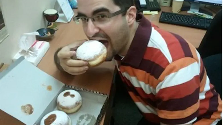 Elie Klein digs into a donut