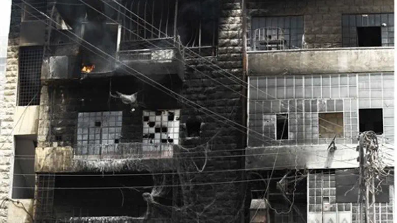 A building burns after shelling at Aleppo
