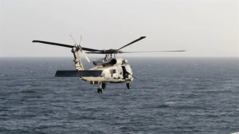 Helicopter flies over Strait of Hormuz