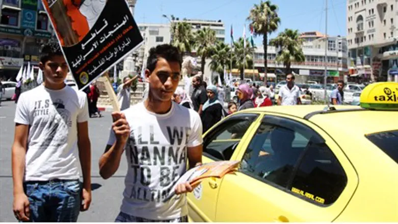 Man waves pro-boycott sign in Ramallah
