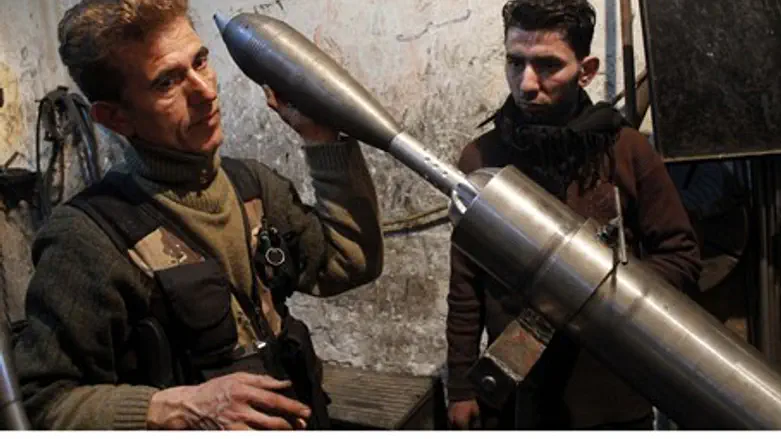 A Free Syrian Army fighter holds an improvise