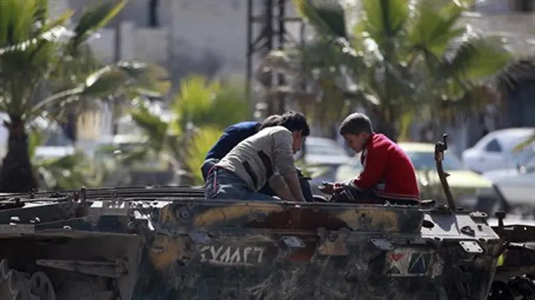 Children play on damaged tank in Aleppo